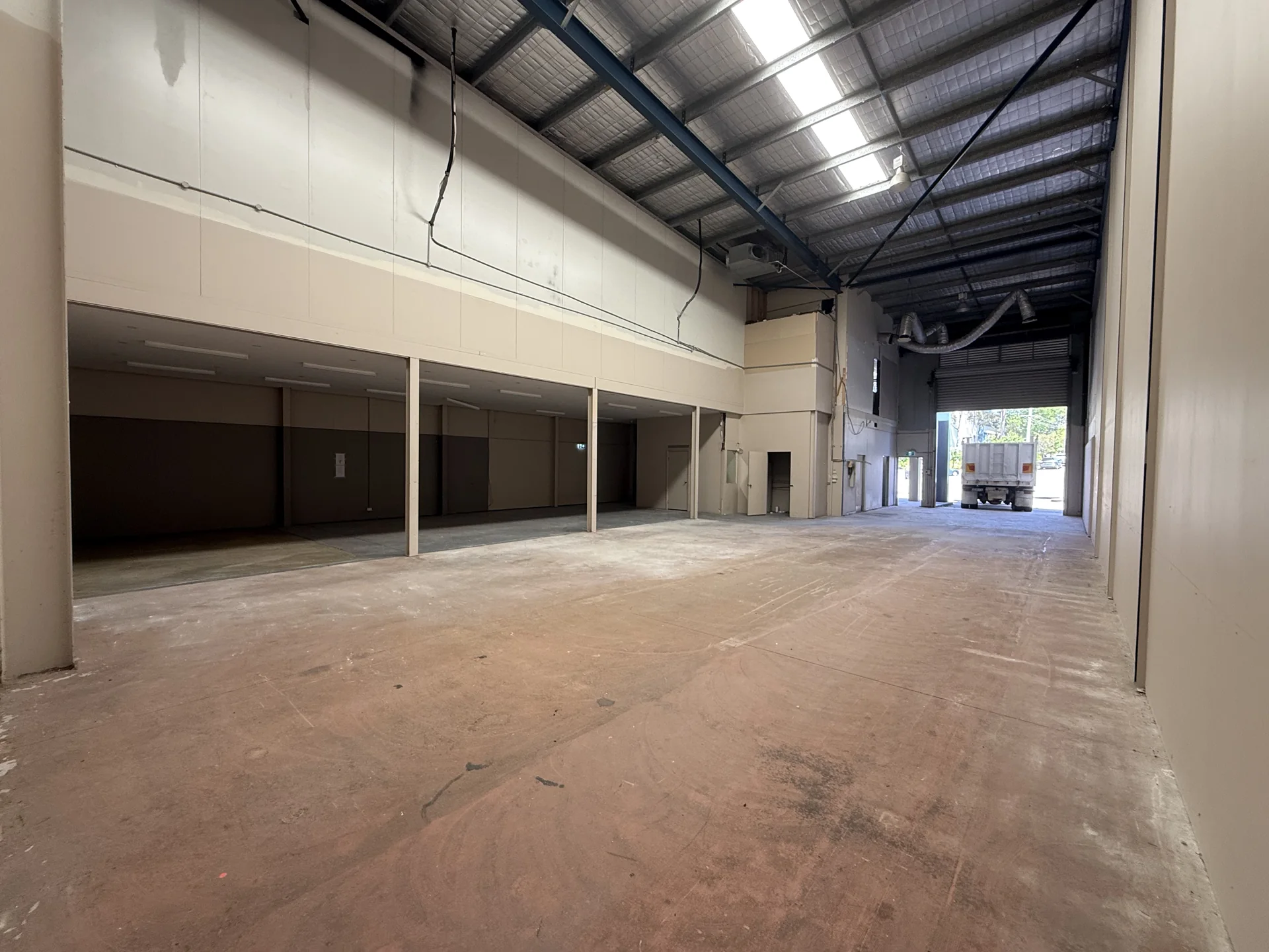Wide view of commercial interior after office and mezzanine strip-out